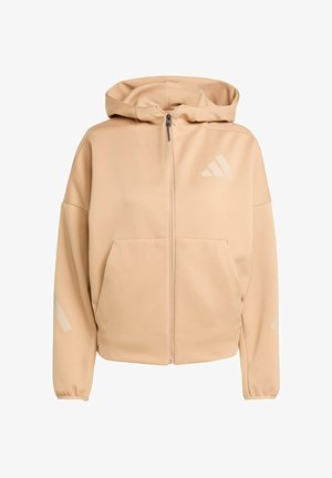 Sweat à capuche beige avec fermeture éclair, grandes poches frontales et accents réfléchissants sur les manches. Présente un logo discret sur la poitrine. Tissu doux au toucher.