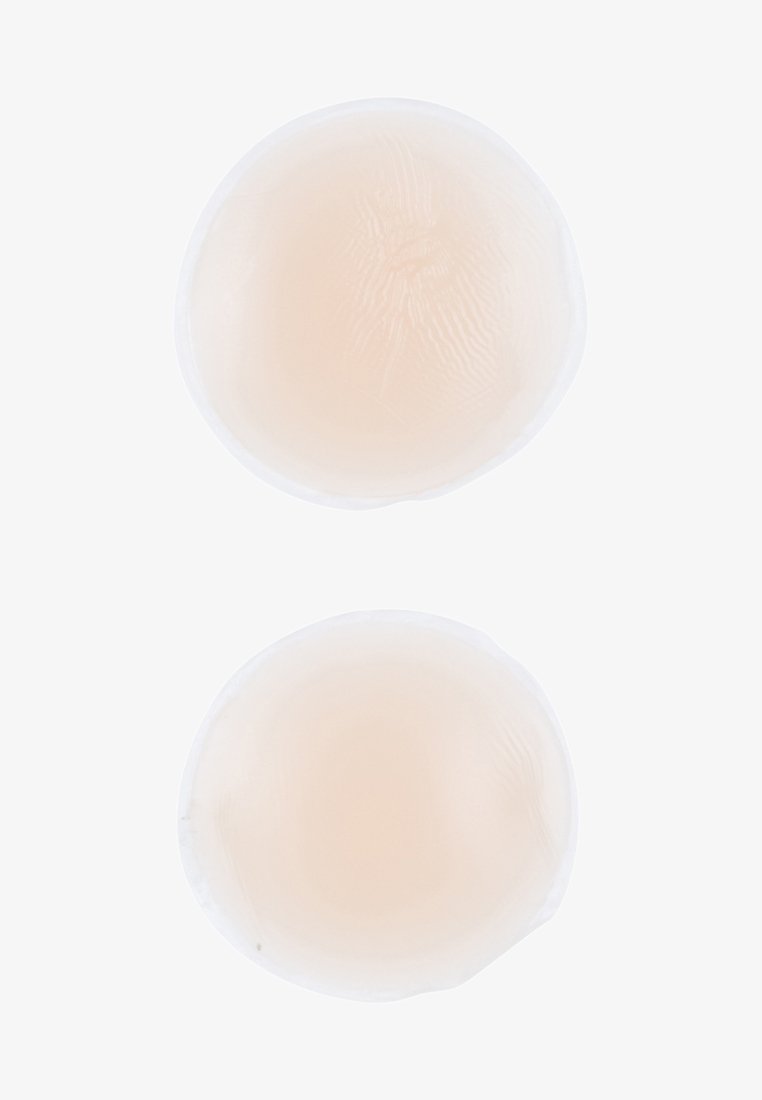 Implanti in silicone per il seno, rotondi, traslucidi, di un colore beige chiaro con una superficie liscia, posizionati come due cerchi sovrapposti.