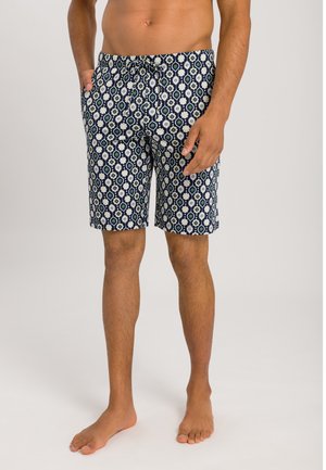 Mørkeblå badebukser med et hvidt og grønt blomstermønster i geometrisk stil, elastisk talje, snøre og sidelommer.