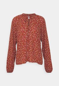 Blusa rossa a maniche lunghe con una piccola fantasia floreale bianca e gialla, scollatura rotonda con apertura a chiave frontale e polsini arricciati.