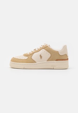 Beige en lichtbruine lage sneaker met witte veters, gestikte zool en Polo-logo aan de zijkant, getoond op een witte achtergrond.