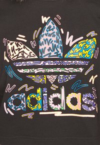 Black sweatshirt featuring a multi-colored, abstract Adidas logo with geometric shapes and various line textures in blue, pink, and yellow.