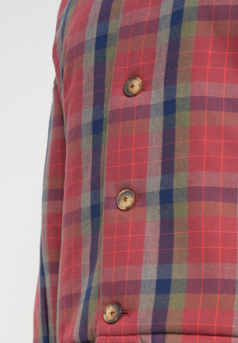 Red plaid shirt featuring a mix of blue, green, and gray lines, with wooden buttons along the front placket and a soft texture.