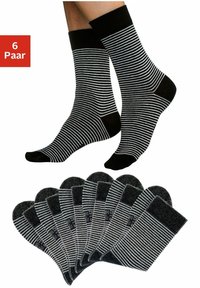 Black and white striped ankle socks displayed. Six pairs arranged, featuring a ribbed cuff and smooth texture.