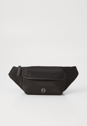 Black fanny pack made of smooth nylon, featuring a front zip pocket and metallic logo accent. Compact design with adjustable straps.