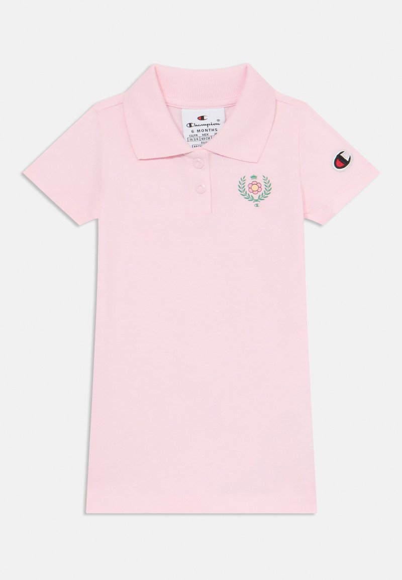 Rosa polo skjorte med krage, korte ermer, dekorasjon med en blomst og blader, samt et logo-patch på ermet.