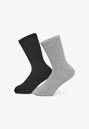 Calzini in cotone neri e grigi, lunghezza fino al polpaccio, con texture a coste, dotati di punta e tallone rinforzati. Design semplice, senza loghi visibili.