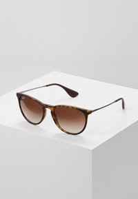 Brown gradient sunglasses with a tortoiseshell frame, plastic lens, and metal accents on the temples, showcasing a classic shape.