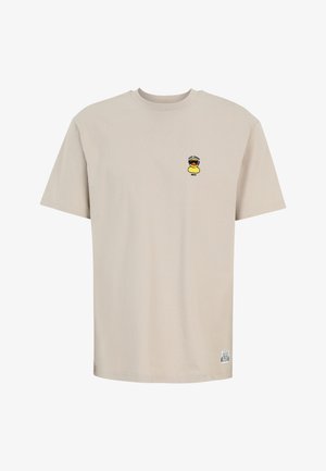 Beige short-sleeve T-shirt with a small yellow rubber duck wearing sunglasses and text "Lazy Sunny Days" on the left chest.