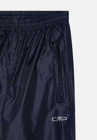 Navy lightweight windbreaker pants with an elastic waistband, zippered side pocket, and a silver logo embroidered on the lower left side.