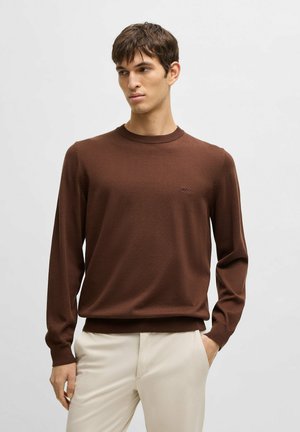 Brown long-sleeve sweater with a crew neckline, made from a soft material, featuring a small logo on the chest and ribbed cuffs.