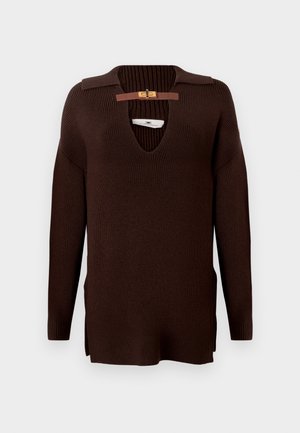 Dark brown ribbed knit sweater with long sleeves, deep V-neck, and a small tan leather strap with gold buckle at the collar.
