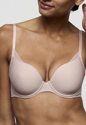Lichtroze beha met naadloze, gevormde cups en verstelbare bandjes. Heeft mesh details langs de zijkanten en een gladde stoftextuur.