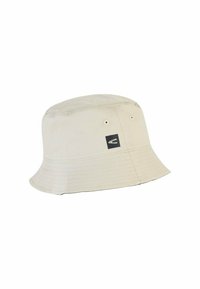 Beige bucket hat made of soft fabric, featuring a wide brim, stitched texture, and a small logo on the side. Round crown design.