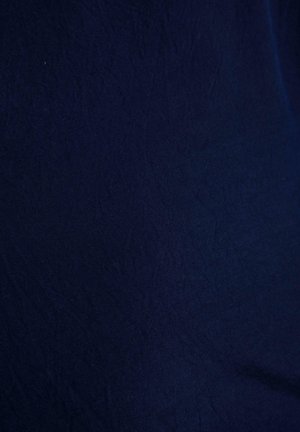 Dark navy blue fabric with soft wrinkles and subtle texture, evenly lit without any other objects or details visible.