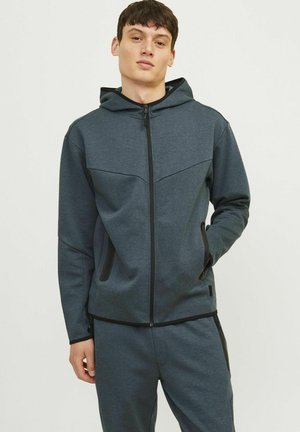 Dark gray zip-up hoodie made of textured fabric. Features a hood, side pockets, and contrasting black accents on the seams.