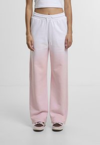 Sweatpants in white with a gradual pink ombre effect. Features an elastic waistband with drawstring and wide leg design. Made from soft fabric.