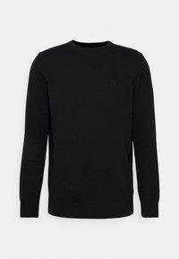 Pull noir en tricot avec manches longues et encolure ronde. Présente un petit logo discret sur la poitrine. Texture lisse et coupe ajustée.