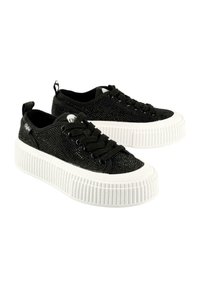 Black sneakers made of textured fabric with a shiny finish, featuring a white, ridged platform sole and black laces.