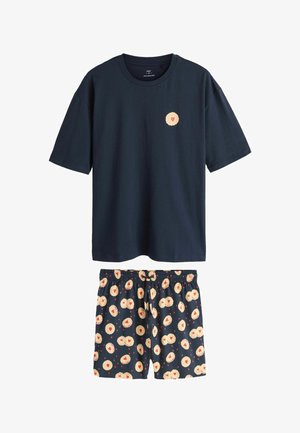Navy cotton short-sleeve t-shirt with a heart-patterned patch, paired with patterned pajama shorts featuring cream and red heart designs.