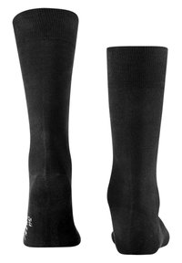 Chaussettes noires montantes en tissu lisse, dotées d'un haut côtelé. Le design est simple, sans motifs ni éléments en métal visibles.