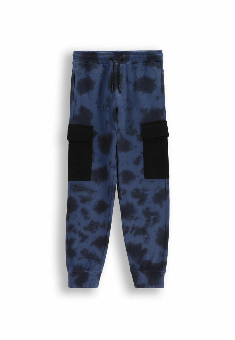 Niebieskie dresy tie-dye z elastycznym pasem, sznurkiem do regulacji i czarnymi kieszeniami na rzepy po bokach. Miękka, teksturowana tkanina o tapered fit.