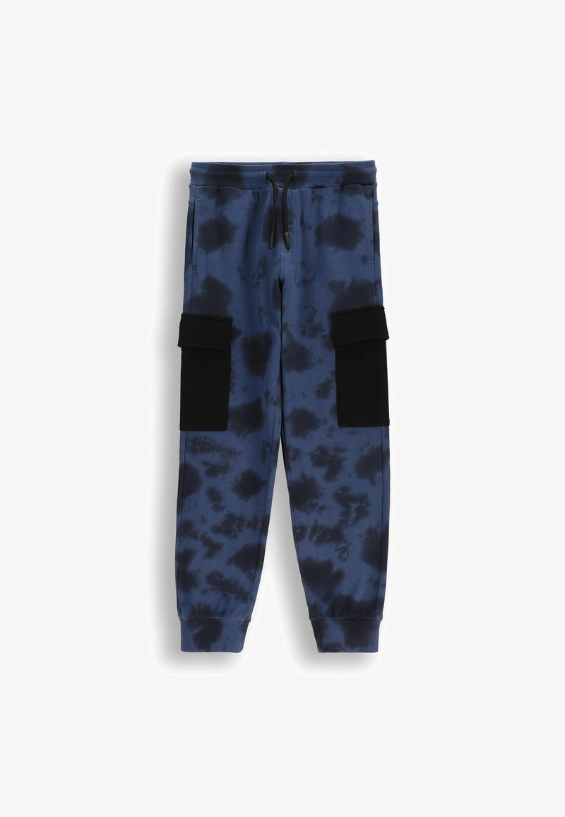 Niebieskie dresy tie-dye z elastycznym pasem, sznurkiem do regulacji i czarnymi kieszeniami na rzepy po bokach. Miękka, teksturowana tkanina o tapered fit.