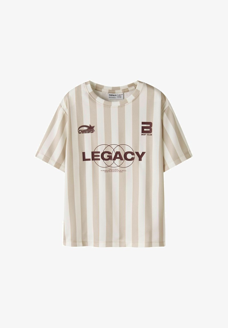 Beige og hvide vertikalt striped kortærmet skjorte med teksten "LEGACY" og en cirkulær design i midten, "CHAMPS" og "BEST CLUB" logoer på brystet.