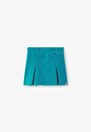 Jupe en velours côtelé turquoise à plis, avec deux boutons décoratifs sur le côté et une petite étiquette logo en tissu en bas à droite.