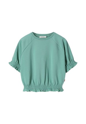 Blouse vert clair à manches courtes avec poignets et ourlet élastiques à volants, encolure ronde, en tissu doux.