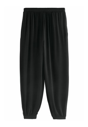 Schwarze lässige Hose aus glattem Stoff. Verfügt über einen elastischen Bund und schmal zulaufende Abschlüsse an den Knöcheln. Einfaches und nahtloses Design.