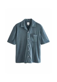 Lyhythihainen, nappikiinnitteinen paita pehmeää vaaleansinistä kangasta, jossa on tekstuuri. Paidassa on rintatasku ja valkoiset napit edessä.