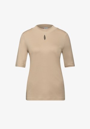 Top beige à manches courtes avec un col haut et un empiècement en forme de trou clé sur le devant. Texture lisse et design ajusté avec une silhouette épurée et minimaliste.