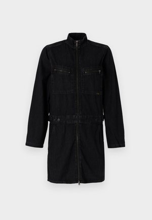 Mustmust mustriided jakke kõrge kaelusega, ees tõmbluku sulgemisega, kahe tõmblukuga rinna taskuga ja reguleeritava vöökohtaga, millel on nupud.