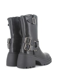 Botas de tobillo de cuero negro con tacón grueso, que presentan dos correas de hebilla de metal ajustables y una cremallera lateral. Suela texturizada para mayor tracción.