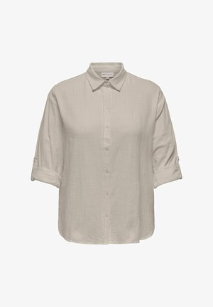 Hele beež värviline triiksärk, millel on üles keeratud varrukad ja tekstuuriga kangas, klassikalise krae ning sirge äärega.