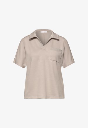 Beigen värinen lyhythihainen poolopaita lovikauluksella ja vasemmalla rinnassa olevalla taskulla, pehmeää kangasta.