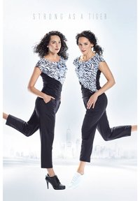 Black athletic pants paired with a zebra print top; models wear contrasting shoes—a black high heel and white sneaker.