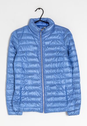 Light blue quilted puffer jacket with stand-up collar and front zipper, displayed hanging on a black hanger against a white background.