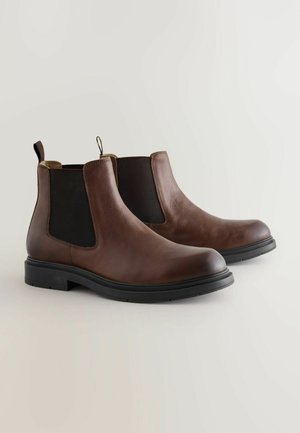 Brown leather chelsea boots with black elastic side panels, rounded toe, pull tab, and textured surface on a black rubber sole.