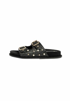 Black slide sandal with textured straps, gold buckles, and decorative pearl and gem studs on white background.