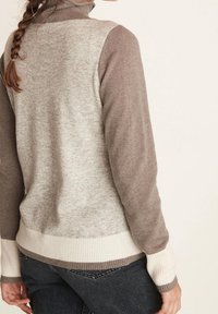 Knit sweater with a high collar, featuring a blend of light gray and brown colors, ribbed hem and cuffs, smooth texture, and color-block design.