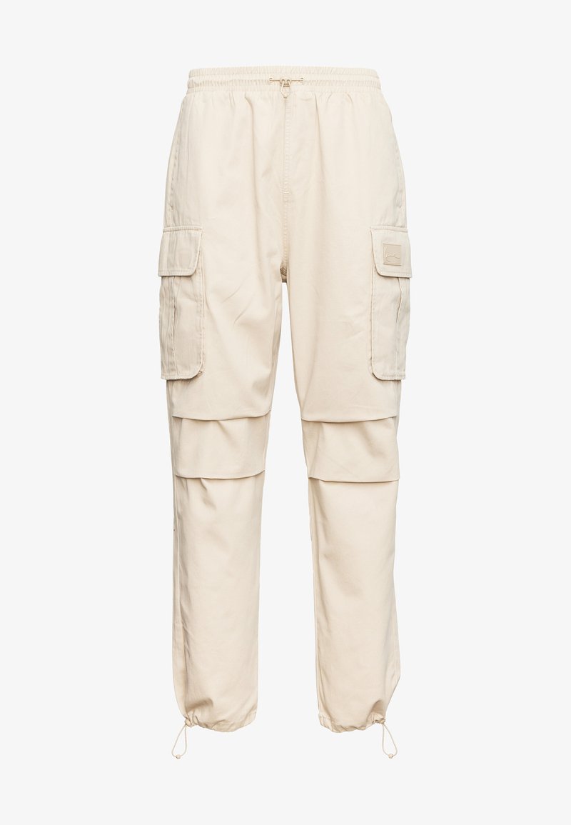 Béžové pracovní kalhoty s elastickým pasem, stahovacími manžetami a několika postranními kapsami. Vyrobené z odolné látky s volným střihem.