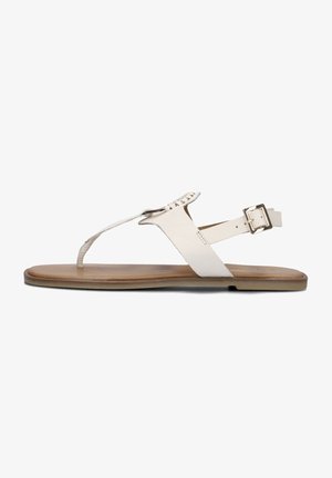 White leather flat sandals with a thong design, adjustable ankle strap, and tan outsole, featuring a subtle woven detail at the toe.