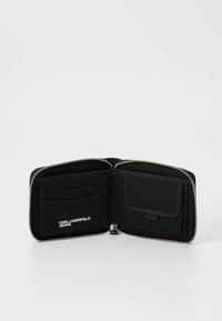 Black zippered wallet with multiple card slots and a pocket. Made from durable fabric, featuring a smooth texture and logo detail.