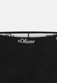 Czarne majtki o gładkiej strukturze, z szerokim elastycznym pasem. Pas ma biały napis "s.Oliver" z przodu.