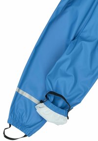 Pantaloni impermeabili albaștri din nylon neted, cu manșete elastice, dungi reflectorizante și șnur reglabil la gleznă.