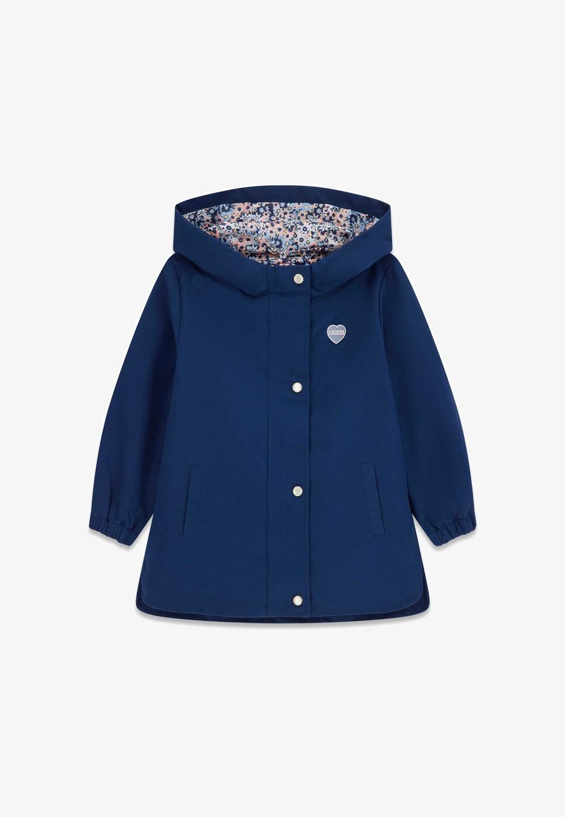 Veste imperméable bleu marine avec une doublure intérieure à motifs floraux, boutons-pression et un logo en forme de cœur sur la poitrine. Poignets élastiques et capuche.