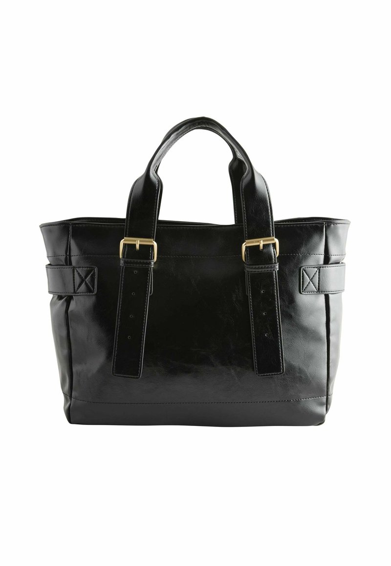 Sac fourre-tout en cuir noir avec double anses, présentant des finitions en métal doré et une forme rigide ; comprend des bretelles ajustables et un fond plat.