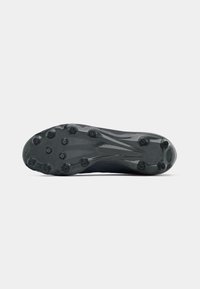Black soccer cleat sole with multiple studs for traction, featuring a textured design and streamlined shape for performance.